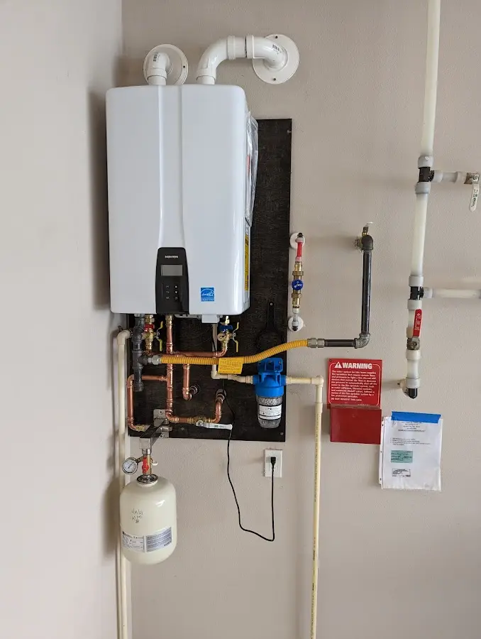 Professional plumber installing copper piping in a Kennewick home